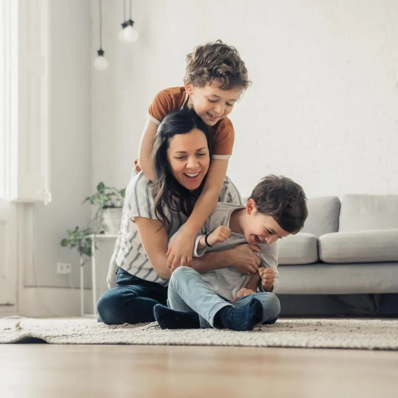 A mother playing with her children at home