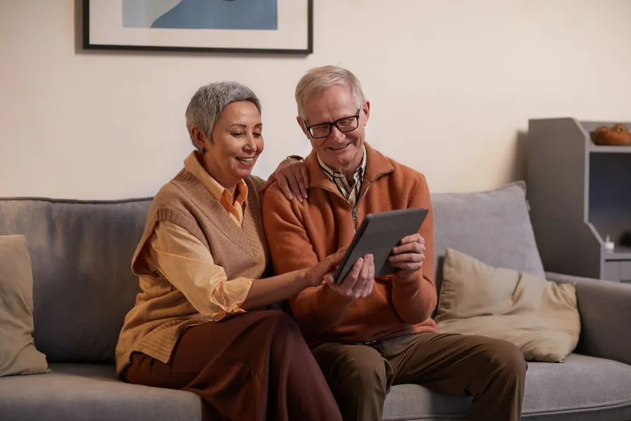 A retired couple relaxing at home