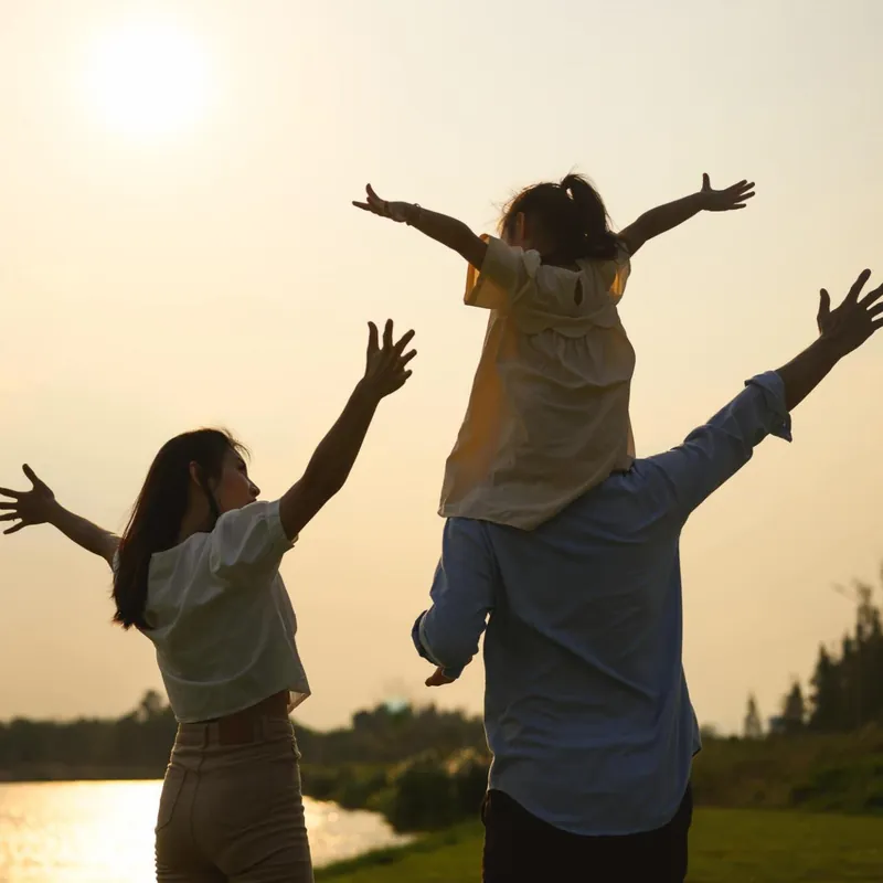 A family silhouetted against a golden sunset