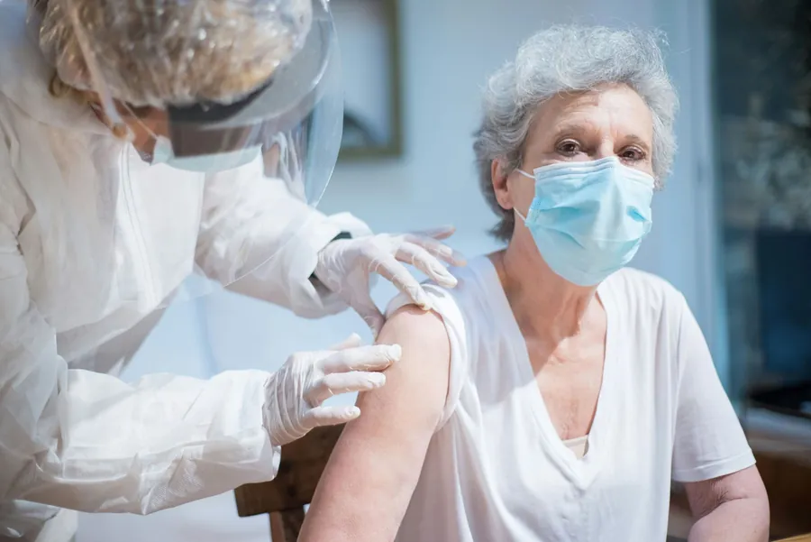 A senior receiving care from a nurse