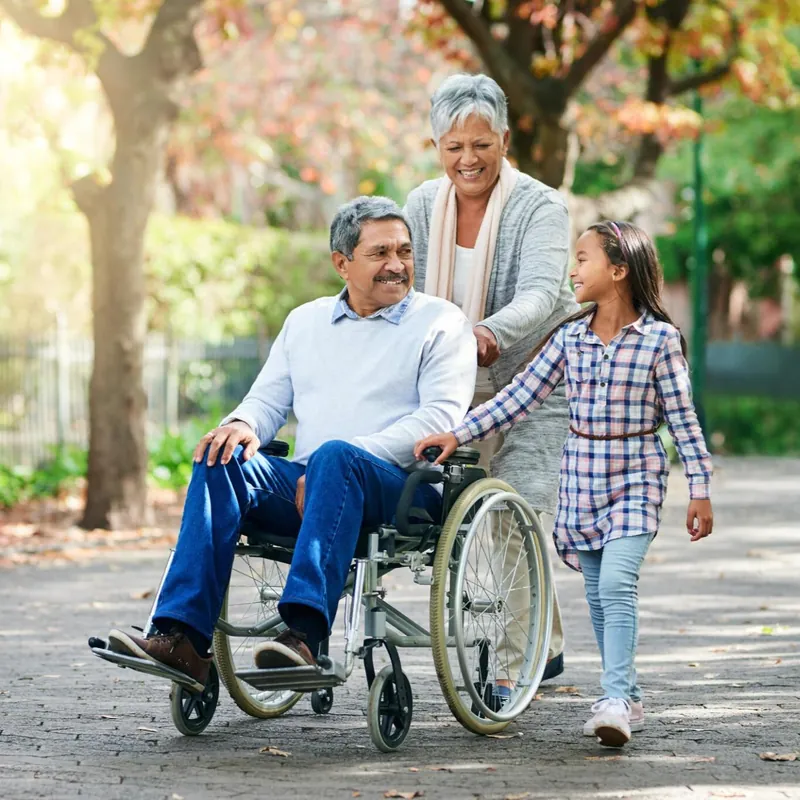 Grandparents walking with their granddaughter